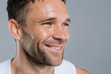 Fototapeta premium young man with radiant smile glistening with sweat exudes happiness after intense workout