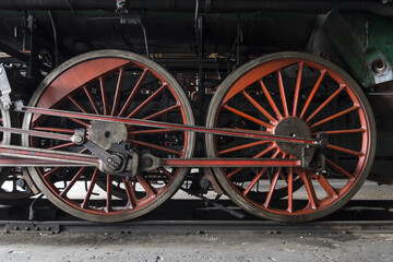 red gears of an old steam locomotive