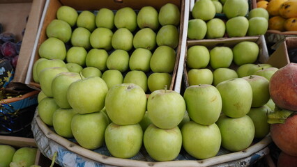 Granny Smith apples stacked high in medium shot