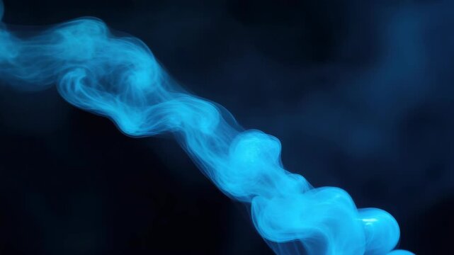 Ethereal blue smoke floating against dark background