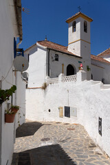 Street of the beautiful white village of Parauta in the Ronda mountains at sunset. Malaga province, Andalucia, Spain.