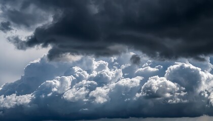Fototapeta premium large dark clouds above cover light clouds below in the sky close up dark and white swirling clouds divide the sky sharp weather change cloudy background