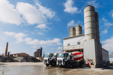Concrete mixer trucks loading at a concrete production plant