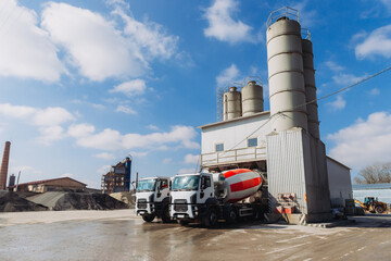 Obraz premium Concrete mixer trucks loading at a concrete production plant