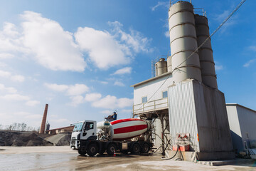Concrete mixer truck loading at production plant