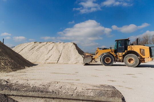 Wheel loader moving sand in concrete production plant