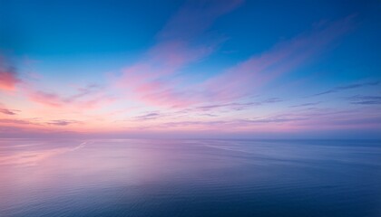 Obraz premium a serene dreamscape of pastel hues blending harmoniously above a tranquil horizon at dusk