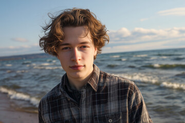 young man, short wavy brown hair, beach in background, wearing plaid shirt