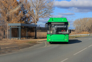 Obraz premium regular bus leaves from a stop