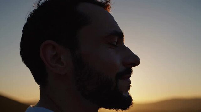 content male person raising upper limbs during dawn scenery inspired by religious devotion and self assurance