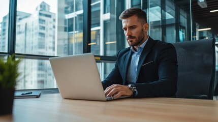 Fototapeta premium Businessman using laptop in office