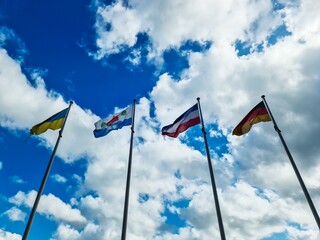Flags of Ukraine, Schleswig Holstein, Netherlands and Germany waving in the wind