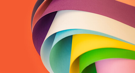 Abstract composition of colorful curved paper sheets in blue, yellow, green and pink against an...
