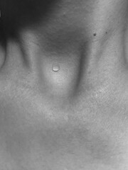 Fototapeta premium A drop of water on the body. Black and white photo of the neck. Body aesthetics. 
