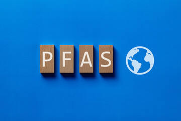 There is wood block with the word PFAS. It is an abbreviation for Per-and Polyfluoroalkyl Substances as eye-catching image.