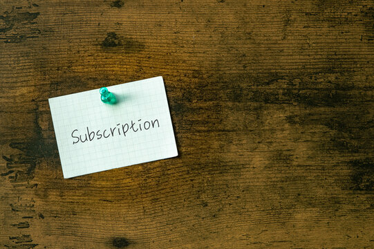 There is a piece of paper with the word Subscription. It is as an eye-catching image.