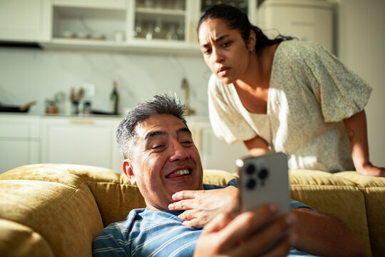 Couple arguing over phone at home