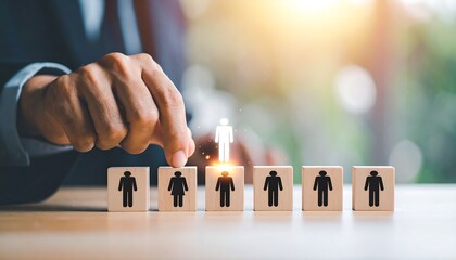 Business person placing a highlighted person figure on a line of wooden blocks