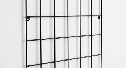 Sleek black metal grid wall organizer subtly reflects soft light. AI Generated
