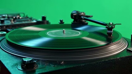 Vintage vinyl record spinning on rotating turntable against green screen background, showcasing seamless motion for music production and visual effects contexts - Powered by Adobe