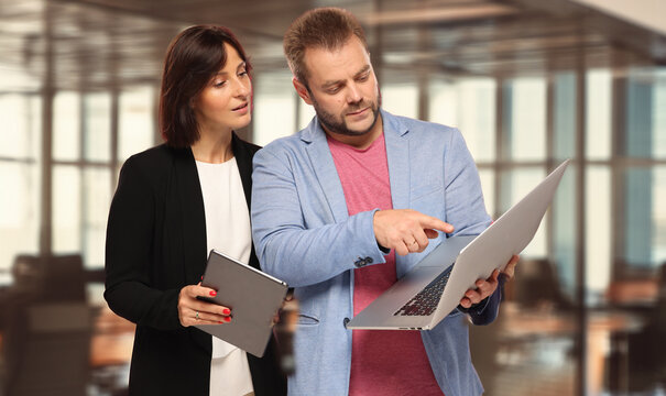 colleagues solve a problem plan discuss two professional people work together use electronic devices