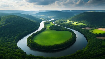 Fototapeta premium Aerial View of River Meander, Lush Green Forests and Fields, Cloudy Sky, Nature