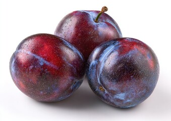 Three plump plums, vibrant purple-red, clustered close together, sit on a plain white background.  Each plum displays a mottled pattern of deep purple and reddish hues. A stem is visible on one plum