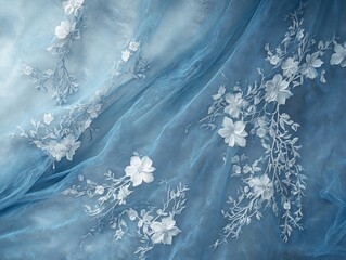 Elegant blue tulle fabric adorned with delicate white floral embroidery design