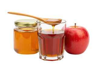 Honey jar, syrup glass with spoon, & a red apple against black backdrop