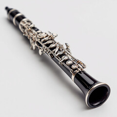 Fototapeta premium Elegant black clarinet with silver keys, carefully aligned on white surface.