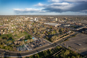 Aerial view of highway interchange and suburban development in Englewood with Denver skyline visible in distance, Colorado, USA