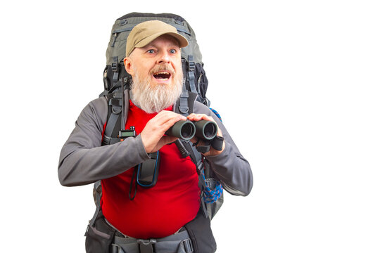Eager hiker with binoculars exploring the wilderness during a sunny day