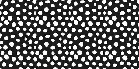 Aesthetic pattern of white dots of different sizes on black background. 