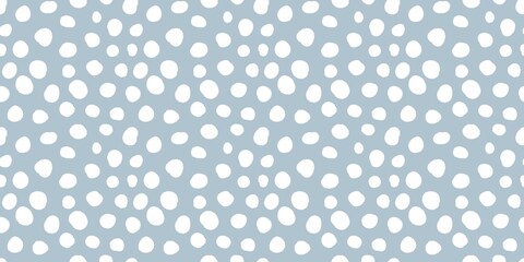 Aesthetic pattern of white dots of different sizes on a pastel blue background. 