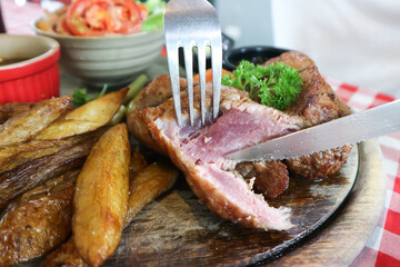 beef steak in gravy sauce or barbecued beef or grilled beef with French fries and vegetable salad