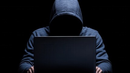 Anonymous Hacker in Hooded Sweatshirt Using Laptop in Dark. Cybersecurity, Cybercrime, Digital Threat.