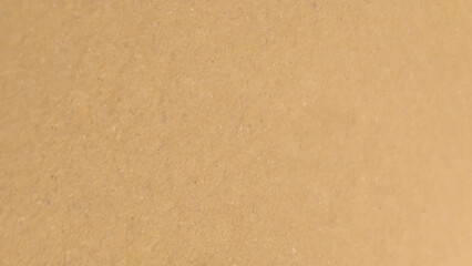 Background of brown kraft paper or cardboard texture. Abstract pattern of beige rough carton, old paper sheet.