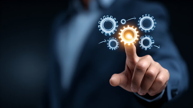 A businessman's hand touches a glowing digital gear, representing process automation and business optimization.
