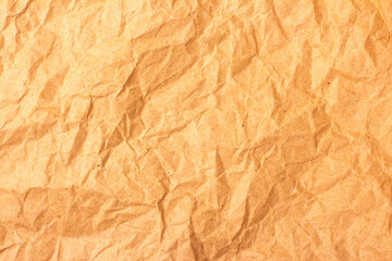 Crumpled brown paper texture with natural folds and creases creating an organic look