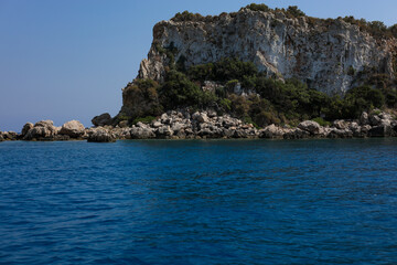 Fototapeta premium Scenic rocky island in the mediterranean sea on sunny day and blue sky. Turquoise water and bright summer atmosphere