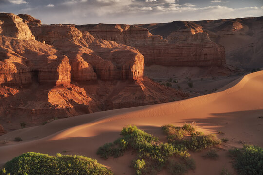 A stunning desert landscape with rocky formations and sand dunes in Mongolia