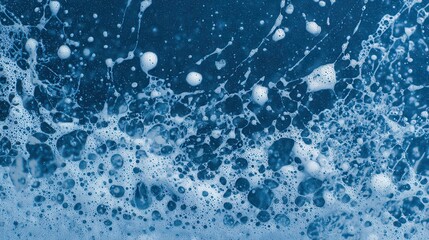 A close-up view of blue water with bubbles and foam, creating a dynamic and textured appearance.