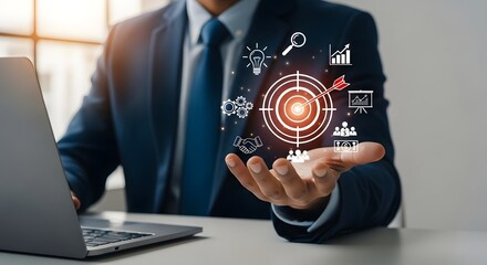 Businessman presenting target with arrow and business icons hovering over his outstretched hand near laptop