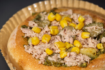 Tuna and Corn Pizza with Pickles and Herbs on a Golden Crust