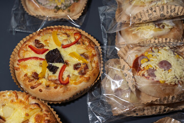 Delicious Mini Pizzas Displayed in Packaging with Various Toppings and Cheese
