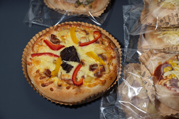 Delicious Mini Pizza Topped with Colorful Bell Peppers and Sausage, Perfect for Snacking or Sharing