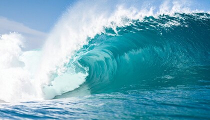 Spectacular view of a massive, powerful blue ocean wave curling into a perfect barrel on a bright sunny day