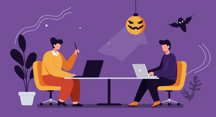 Two colleagues work on laptops in a festive Halloween-themed office, collaborating under the glow of a jack-o'-lantern. Ideal for business, technology, and holiday work concepts.