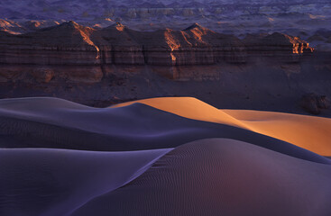 The Mesmerizing Sand Dunes bathed in Sunset Glow within Desert Landscape
