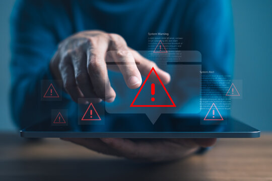 Cybersecurity system alert with warning icons on digital tablet screen, representing data breach, cyber attack, system failure, and IT risk in digital technology environments